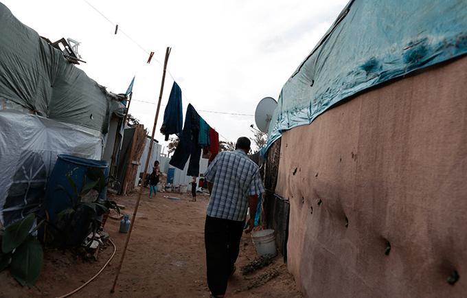 A community leader makes his way to the tent of a pregnant 14-year-old former child bride. “I am worried about the delivery,” said the girl’s father. © UNFPA/David Brunett